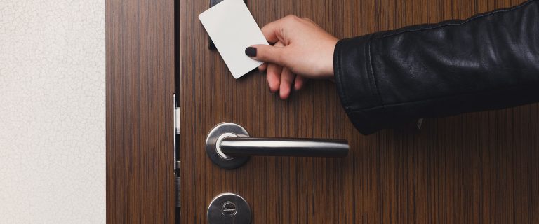 Hand inserting key card in electronic lock