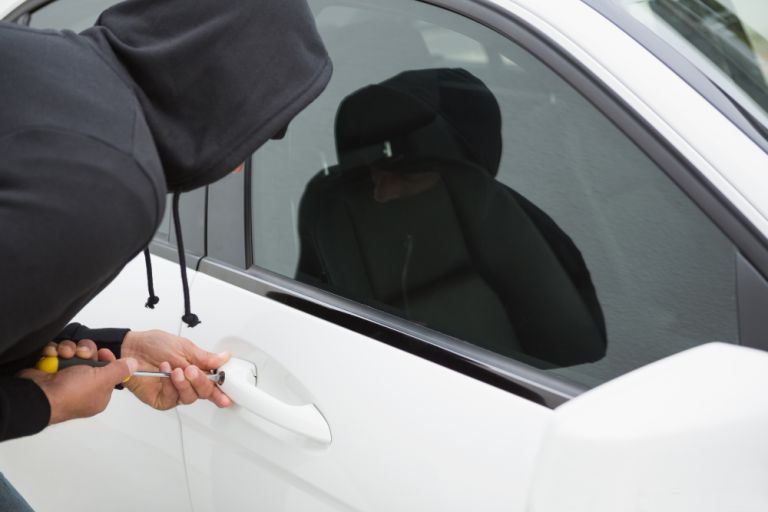 thief-breaking-into-car-with-screwdriver
